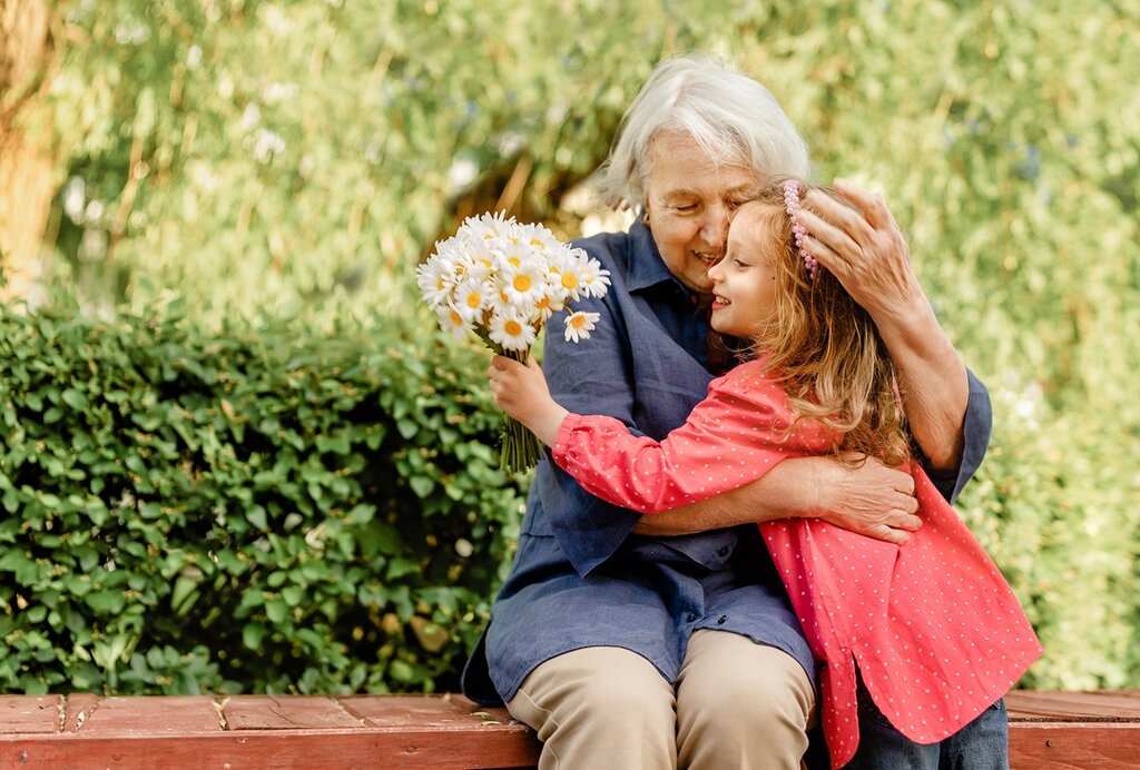 A grandmother cuddling her granddaughter